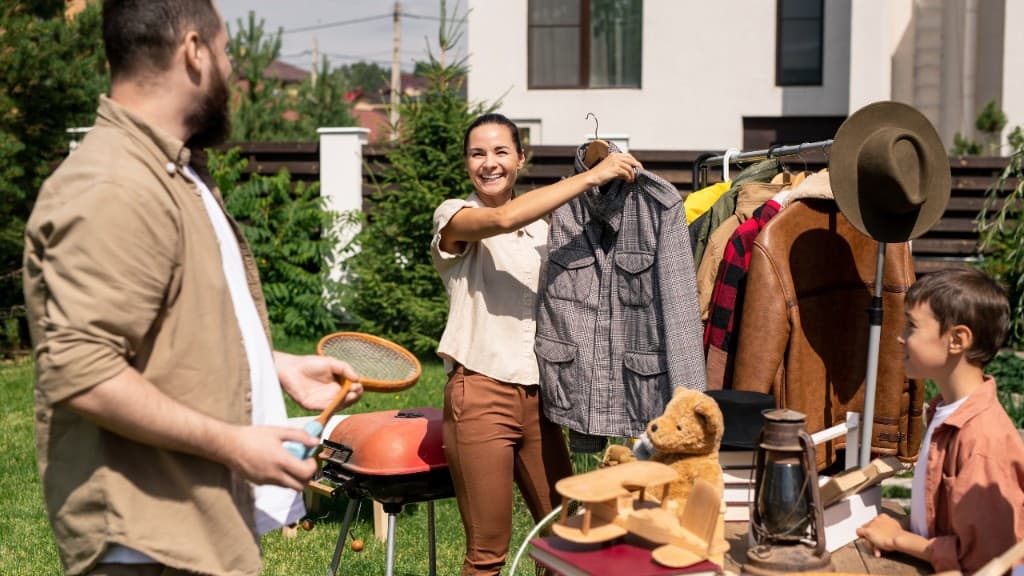 A couple sourcing items at an outdoor yard sale